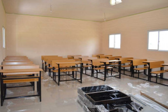 assembling new desks provided by Ministry of Education