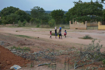 village kids carrying water